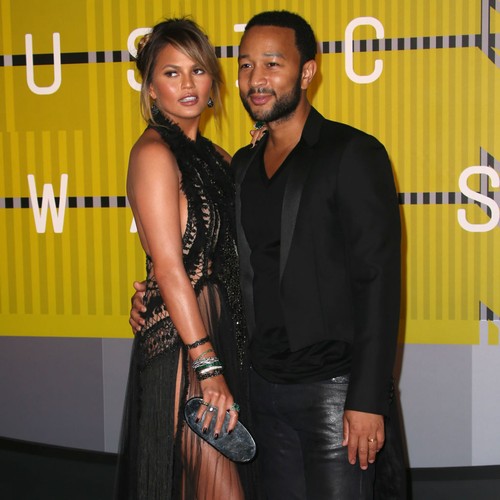 Teigen ‘rubs baby belly for luck’
